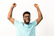 African American man with glasses celebrating a victory, arms raised in excitement, isolated on a white background, conveying happiness and positive emotions.