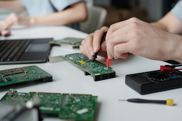 Poster - Unrecognizable technician of repair service center with electric handtool checking motherboard and identifying technical problem