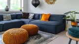 Fototapeta  - Modern living room. Two knitted pouffes near a dark blue corner sofa. Scandinavian home interior design modern living room