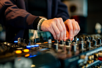 Wall Mural - woman DJ Hands creating and regulating music on dj console mixer in concert