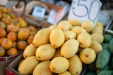 Fototapeta Dmuchawce - Group of ripe mangoes are selling at the fruits market. Freshness fruits object photo.