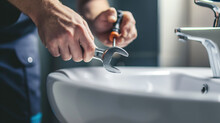 Closeup Plumber Hand Repairing Leaking Sinks With Adjustable Wrench In The Bathroom