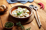 Fototapeta Maki - Homemade dumplings on a wooden background.