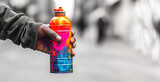 Fototapeta  - Graffiti spray can with in hand. Black and white blurred background, banner with copy space.