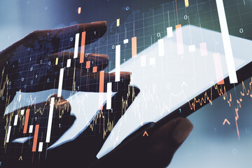 Poster - Multi exposure of abstract financial graph with world map and hand working with a digital tablet on background, financial and trading concept