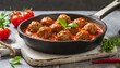 Beef meatballs in tomato sauce in a pan.

