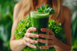 Woman with green juice detox smoothie jar. A girl hand with a green juice detox smoothie with a straw.