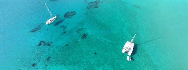 Canvas Print - Aerial drone ultra wide photo of beautiful catamaran sail boat sailing in tropical exotic bay with emerald clear sea