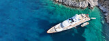 Fototapeta  - Aerial drone ultra wide top down photo with copy space of luxury yacht anchored in tropical exotic island with crystal clear turquoise sea