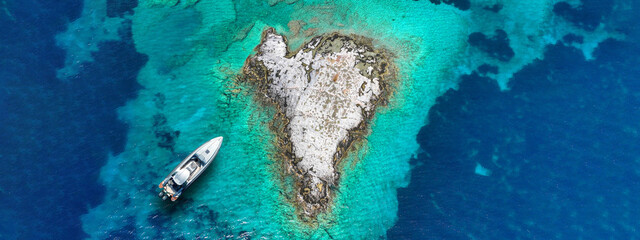 Wall Mural - Aerial drone ultra wide photo of secluded heart shaped island with turquoise sea in Caribbean exotic destination