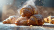 Close-up of freshly baked croissants in powdered sugar, with pink icing on the table, top view. Food concept.