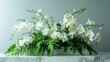 An elegant arrangement of ivory orchids and delicate ferns, sprawling across a sleek marble countertop.