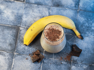 Wall Mural - Banana smoothie with chocolate, sweet milk dessert.
