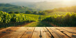 Empty wood table top with blurred vineyard