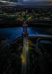 Poster - the city at night with an illuminated bridge in the middle