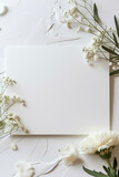 Fototapeta  - mock up image of paper and flowers on white background, in the style of brown and bronze, minimalist canvases, white and brown, top view