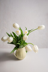 Wall Mural - A bouquet of white tulips in a yellow jug