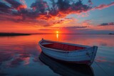 Fototapeta Zachód słońca - A solitary red and white boat on tranquil water against a backdrop of a dramatic sunset