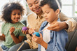© Maria Vitkovska - Portrait happy African American family decoration and painting Easter eggs at home. Smiling mother and kids preparation for Easter together. Holiday activity concept