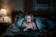 Young girl addicted to her mobile phone in a dark bedroom