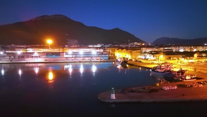 Wall Mural - Dusk lights and fishing boats in the fishing village of Santoña in the Marismas de Santoña, Victoria y Joyel Natural Park. Cantabrian Sea. Santoña, Cantabria, Spain, Europe