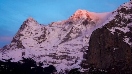 Wall Mural - View of mont blanc, in the french alps and clouds. Timelapse of the clouds covering the mountain during beautiful sunset.