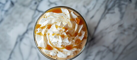 Sticker - A top-down view of a freshly made caramel latte with a dollop of whipped cream, placed on a wooden table. The cup is steaming, indicating it is freshly brewed.