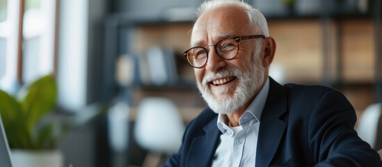 Poster - a senior financial advisor with a beard and glasses is focused on his computer screen, possibly anal