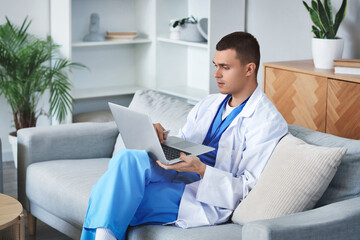 Poster - Young doctor video chatting with patient on laptop at home