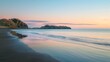 Panoramic view of a serene beach at sunrise with soft pastel colors reflecting on the calm sea.