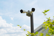 CCTV Camera, Two High-definition Security Cameras Are Mounted On A Pole In Front Of A Bank.