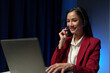 © crizzystudio - Service worker, call center attractive Asian woman smiling communicating via online internet video using laptop computer with headset microphone typing data on keyboard for financial business service