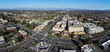 Aerial panoramic view of city center of Cupertino, California. Intersection of Stevens Creek Blvd and De Anza Blvd. Silicon Valley skyline. 