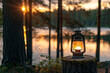Camping lantern on the stump in the forest at sunset