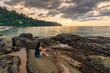 © Noppasinw - Tropical sea beach sunset with woman tourist on rock coast and ocean wave at Khao Lak, Phang Nga Thailand nature landscape