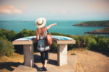 Woman pointing island and sea- travel destination, vacation,tour tourism in France, Brittany