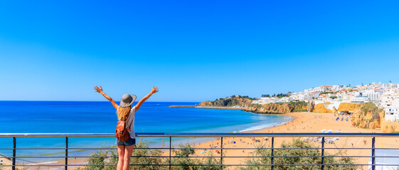Wall Mural - happy woman with arms raised up enjoying panorama view of sea- travel, vacation, summer holiday conc