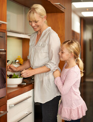 Sticker - Mother, daughter and food preparation in kitchen, happy and salad for healthy meal in home. Girl, mommy and support in learning for child development, love and bonding with nutrition and vegan diet