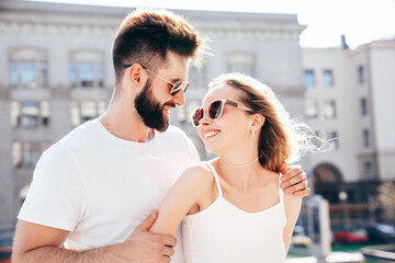 Smiling beautiful woman and her handsome boyfriend. Woman in casual summer clothes. Happy cheerful family. Female having fun. Couple posing in street at sunny day. Having tender moments