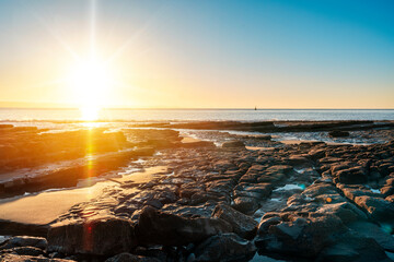 Wall Mural - amazing sunrise over the rocky coast in winter