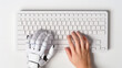 © Nitcharee - White robot hand and human hand typing and work on Key board , Collaborate work , AI , Artificial intelligence and a technology.