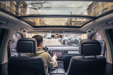 Wall Mural - Man touching screen of a GPS navigation system in his car.