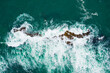 Aerial view of crashing waves on rocky shoreline