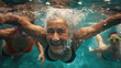 Smiling elderly woman swimming underwater with others