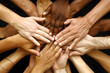 © Maleesha - A group of diverse hands joined in unity forming a circle, human hands, team work and unity concept