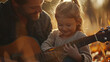 Father and young daughter playing guitar, teaching a young child to play guitar