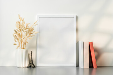 Wall Mural - Blank picture frame and dried flower in a vase on white background