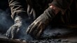 Close-up of chimney sweep's hands covered in soot as he removes creosote buildup from chimney