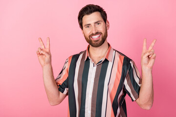 Poster - Portrait of satisfied glad young person toothy smile arms fingers demonstrate v-sign isolated on pink color background