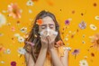 © iloli - girl sneezing into handkerchief, on a yellow background, flying flowers around, concept spring, allergy